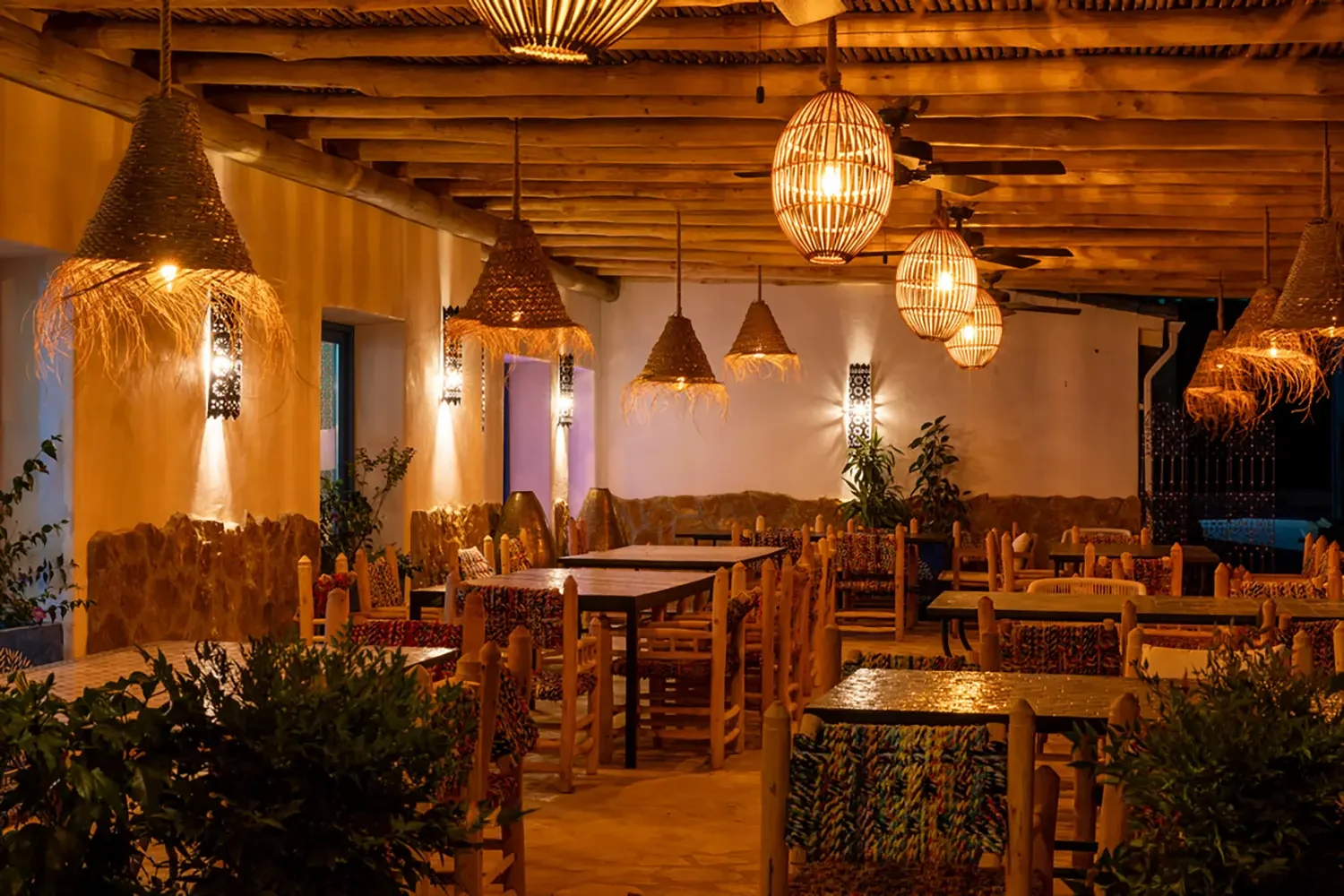 A table laid on the terrace at Jardín Dorado under warm lighting